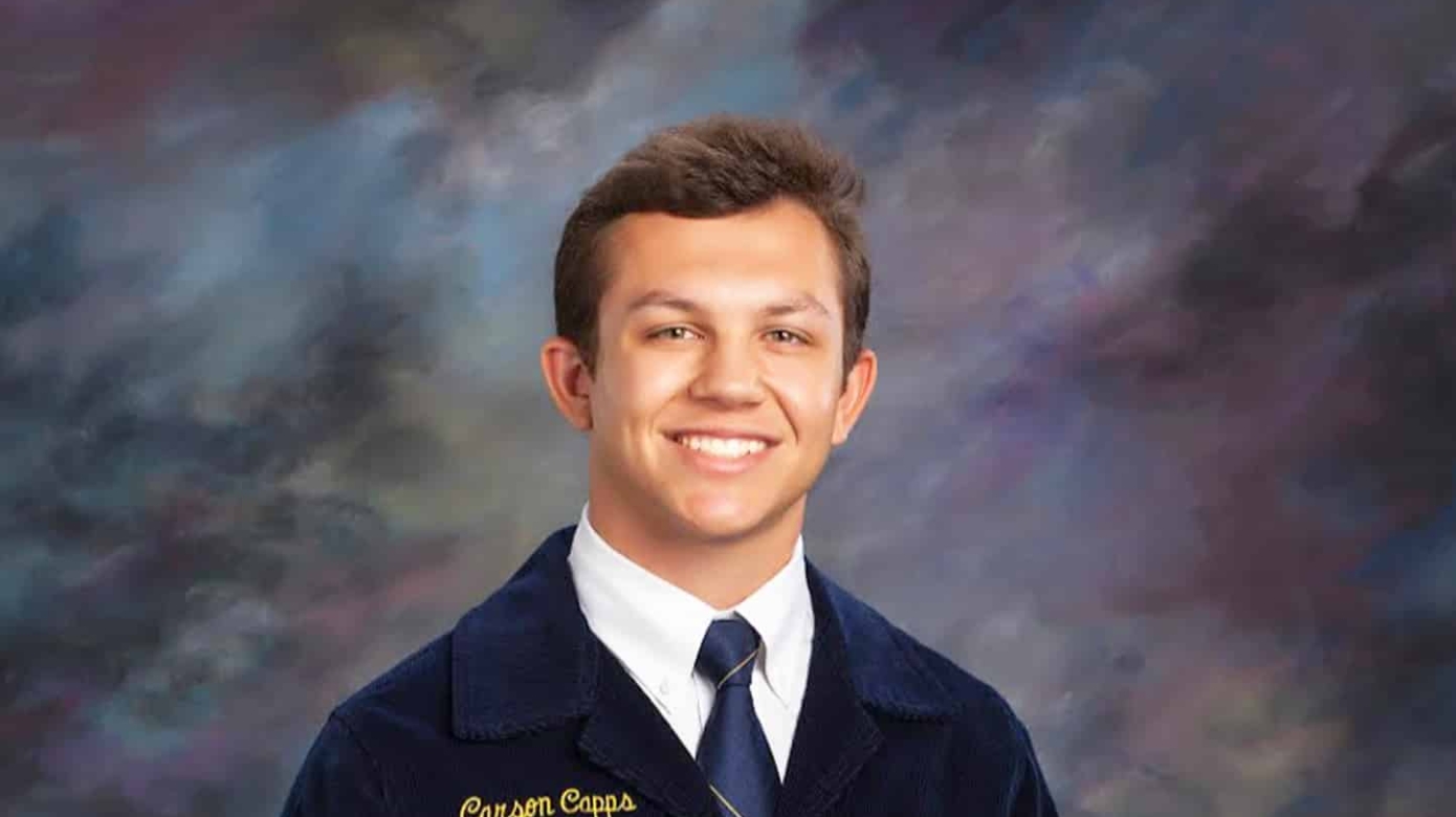 Portrait of Carson Capps in his Oklahoma FFA jacket, embroidered with the school year 2021-2022 and the title Vice-President for the Southeast Area.