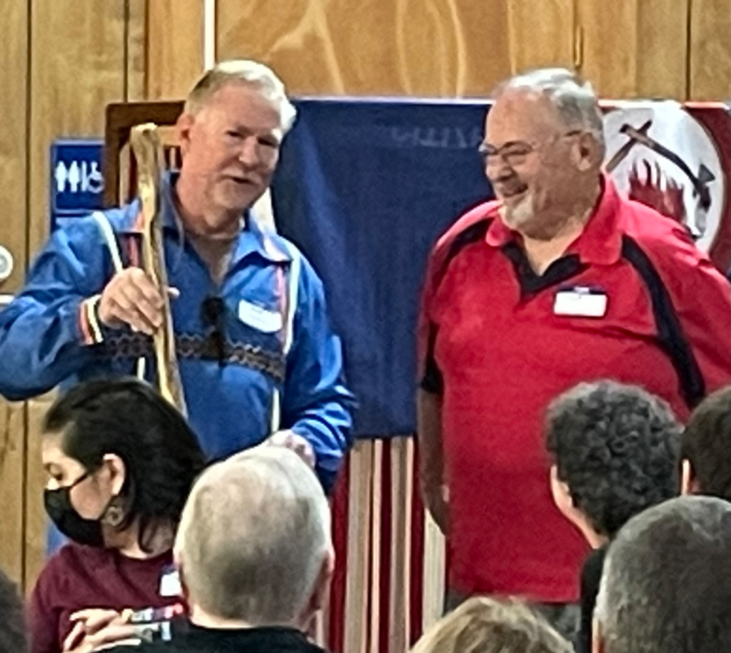 Dave Carney, left, in a blue ribbon shirt, speaks with Steve Lynch, right, in a red polo shirt.